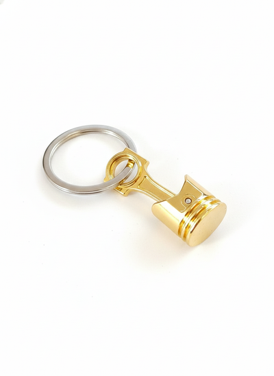 Portachiavi in metallo color oro a forma di pistone con biella mobile, gadget per auto e moto